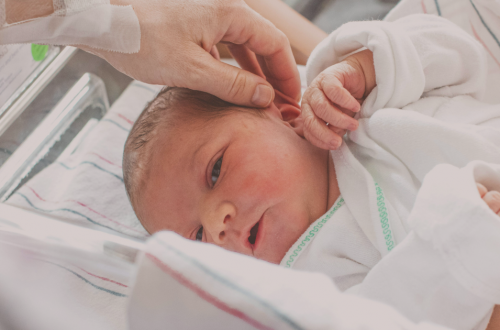 bébé né après un accouchement qui s'est bien passé, sa maman lui caresse les cheveux